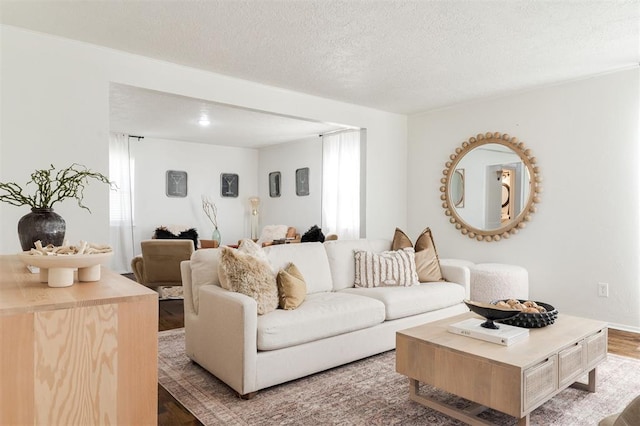 living room featuring plenty of natural light, a textured ceiling, and wood finished floors