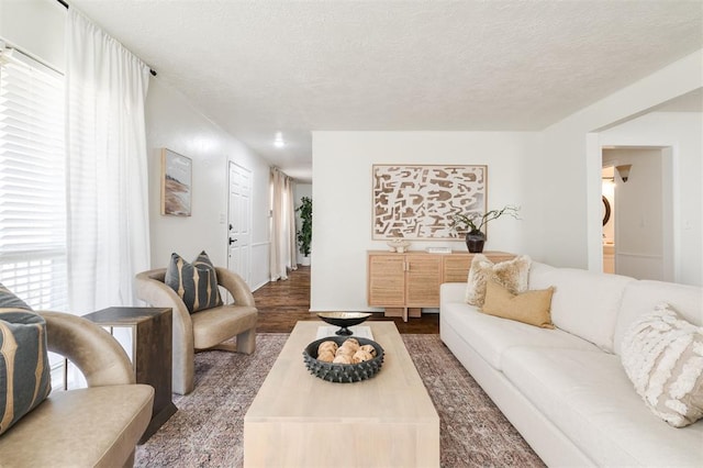 living area with a textured ceiling and wood finished floors