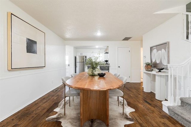 dining room with visible vents, stairway, dark wood-type flooring, and baseboards