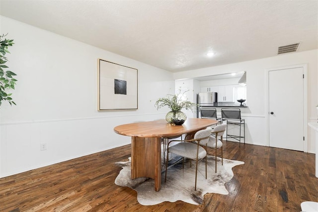 dining room with visible vents and wood finished floors