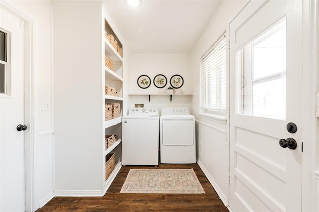 laundry area with dark wood-type flooring, separate washer and dryer, and laundry area