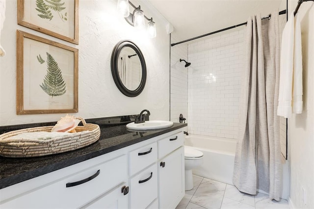 bathroom with vanity, toilet, marble finish floor, and shower / tub combo