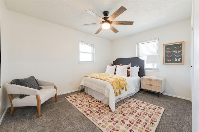 bedroom featuring ceiling fan, carpet, baseboards, and a textured ceiling