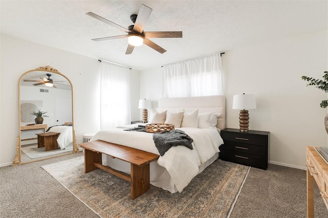 bedroom with a ceiling fan, carpet, baseboards, and a textured ceiling