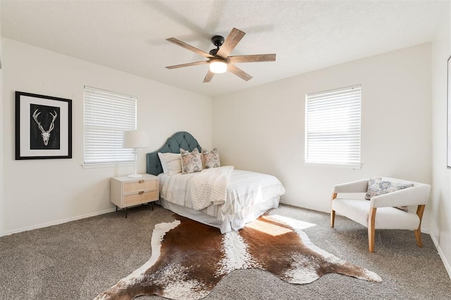 bedroom with carpet flooring, multiple windows, a ceiling fan, and baseboards