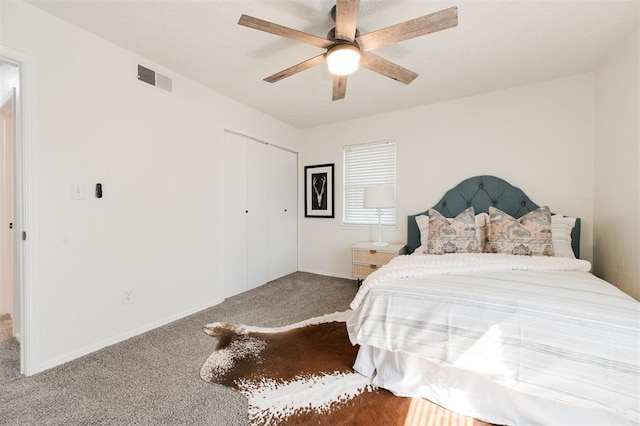 bedroom with visible vents, baseboards, carpet, a closet, and a ceiling fan