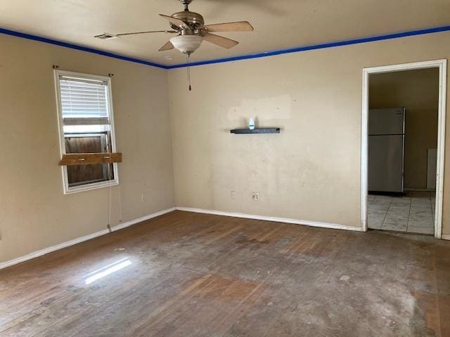 unfurnished room with wood finished floors, baseboards, ornamental molding, and a ceiling fan