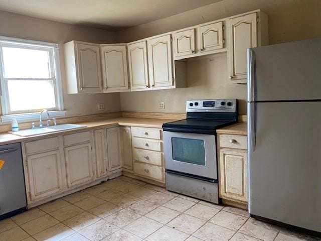 kitchen with a sink, light countertops, and stainless steel appliances