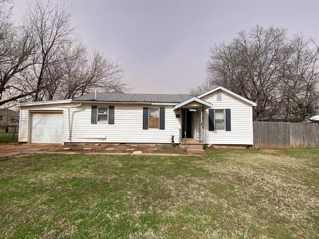 single story home featuring a front lawn, fence, crawl space, and metal roof