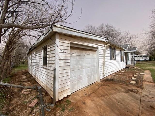 view of property exterior with a detached garage