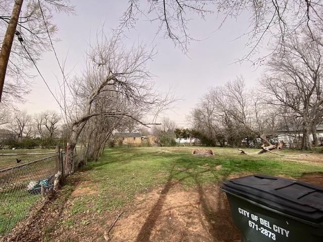 view of yard featuring a rural view and fence