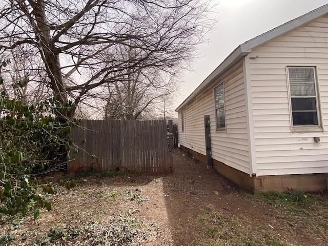 view of side of home with fence