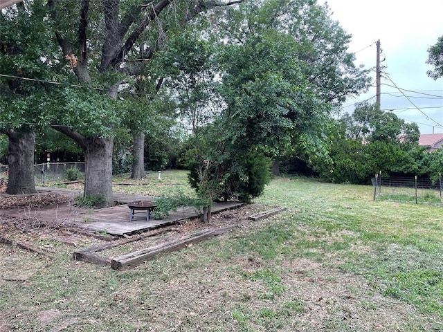 view of yard with a fire pit and fence