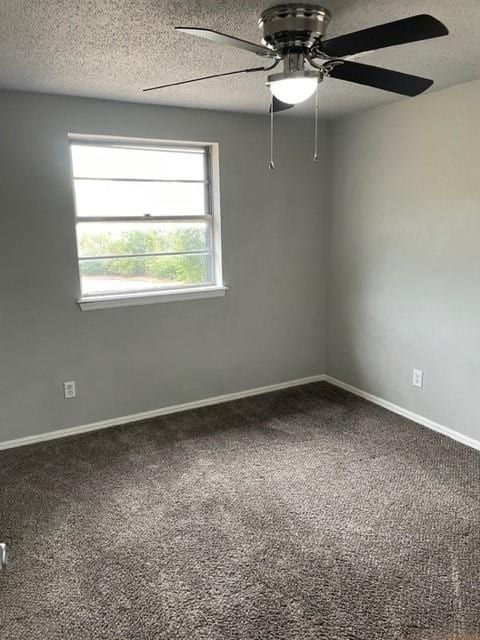 unfurnished room featuring a textured ceiling, carpet flooring, baseboards, and ceiling fan