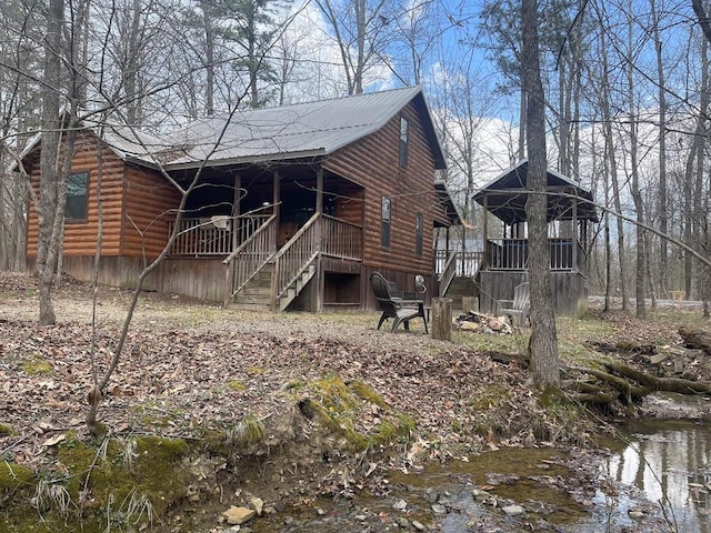 exterior space with stairway and faux log siding