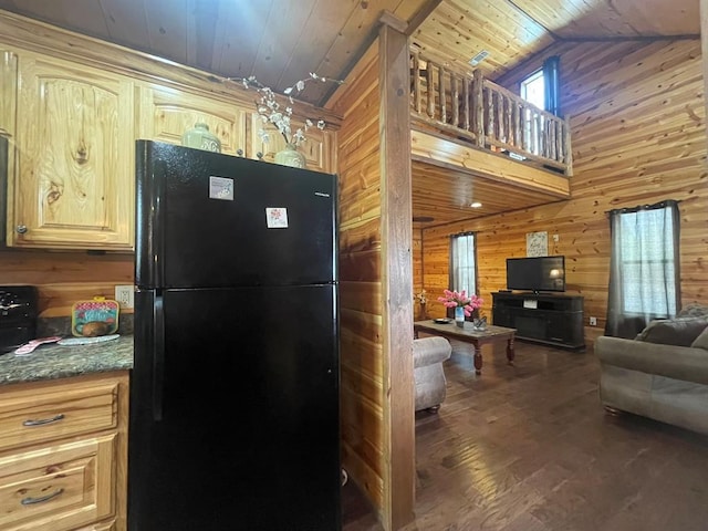 kitchen with open floor plan, wood walls, wood ceiling, and freestanding refrigerator