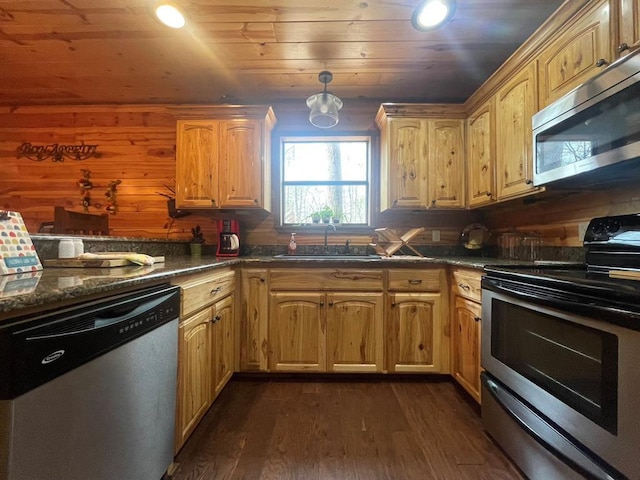 kitchen featuring a sink, dark countertops, dark wood finished floors, appliances with stainless steel finishes, and wooden ceiling