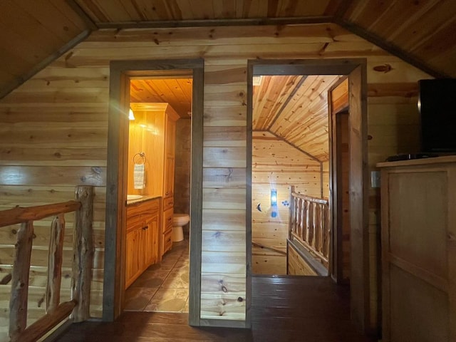 hall with wood ceiling and wood walls