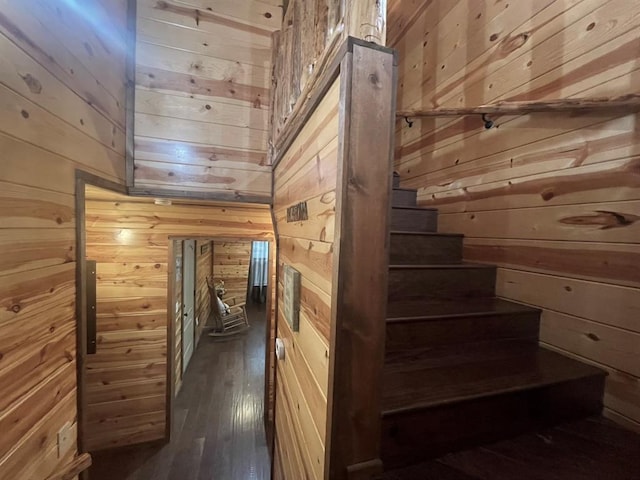 staircase with wood walls and hardwood / wood-style flooring