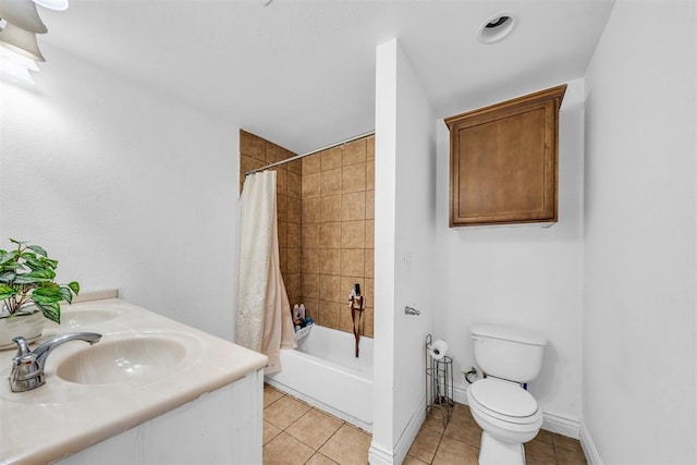 bathroom with baseboards, shower / bath combo, a sink, tile patterned floors, and toilet