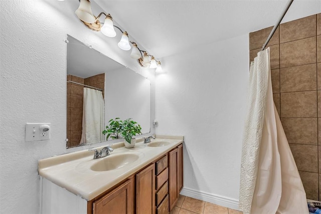 full bath with a sink, a shower with shower curtain, double vanity, and tile patterned floors