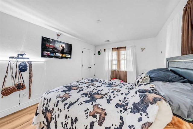 bedroom with visible vents and light wood finished floors