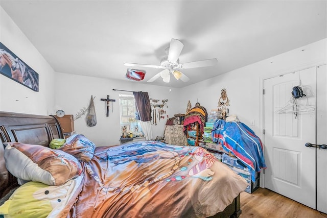 bedroom with ceiling fan and wood finished floors