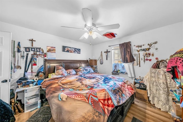 bedroom with wood finished floors and a ceiling fan