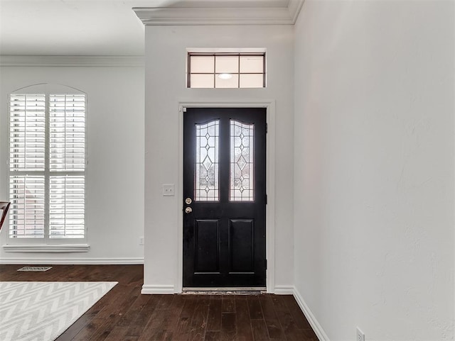 foyer featuring a healthy amount of sunlight, baseboards, crown molding, and dark wood-type flooring