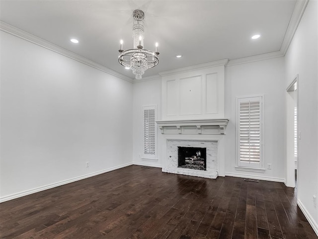 unfurnished living room featuring a brick fireplace, an inviting chandelier, dark wood-style floors, and ornamental molding