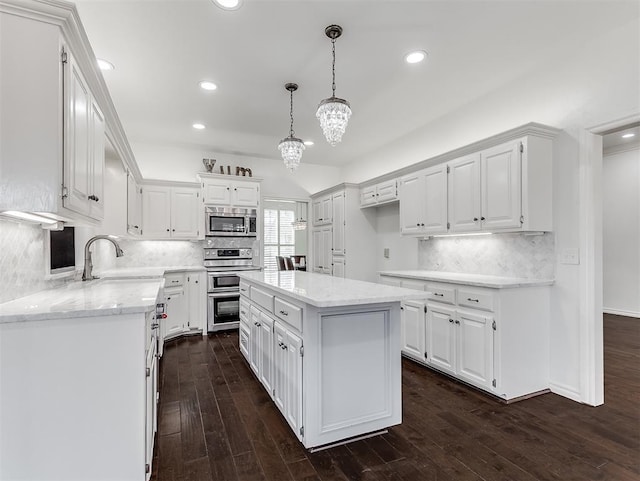 kitchen featuring white cabinets, dark wood-style floors, appliances with stainless steel finishes, and a sink