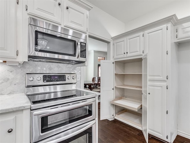 kitchen featuring dark wood-style floors, appliances with stainless steel finishes, white cabinetry, and open shelves