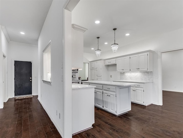 kitchen featuring tasteful backsplash, dark wood finished floors, white cabinetry, and light countertops