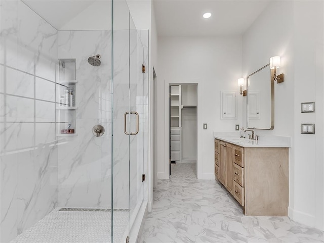 full bathroom featuring a marble finish shower, baseboards, marble finish floor, and vanity