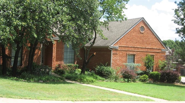 2809 Red Fern, Edmond, OK 73034 - view of front of property featuring brick siding, a front yard, and a shingled roof