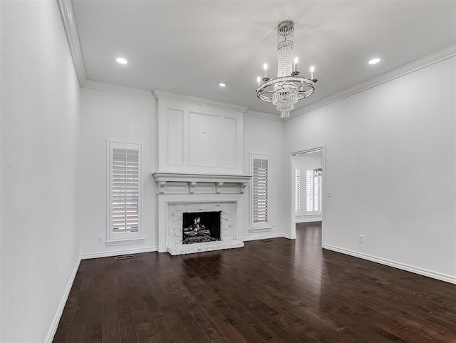 2809 Red Fern, Edmond, OK 73034 - unfurnished living room featuring crown molding, a chandelier, dark wood finished floors, a high end fireplace, and recessed lighting