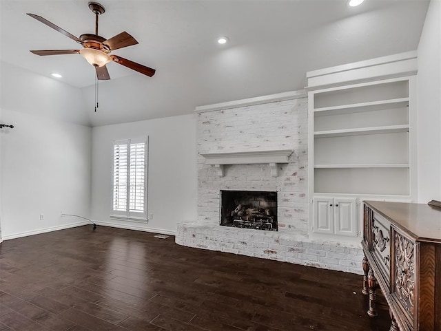2809 Red Fern, Edmond, OK 73034 - unfurnished living room with dark wood finished floors, a ceiling fan, vaulted ceiling, a fireplace, and recessed lighting