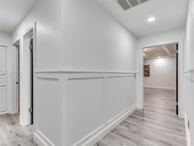 2809 Red Fern, Edmond, OK 73034 - hall featuring light wood-style floors, wainscoting, and a decorative wall