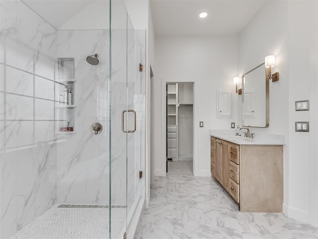 2809 Red Fern, Edmond, OK 73034 - bathroom featuring a marble finish shower, vanity, marble look tiles, a walk in closet, and recessed lighting