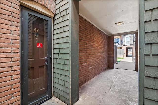 property entrance with brick siding