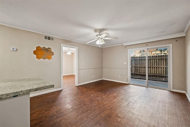 unfurnished room with visible vents, ornamental molding, ceiling fan, and wood finished floors