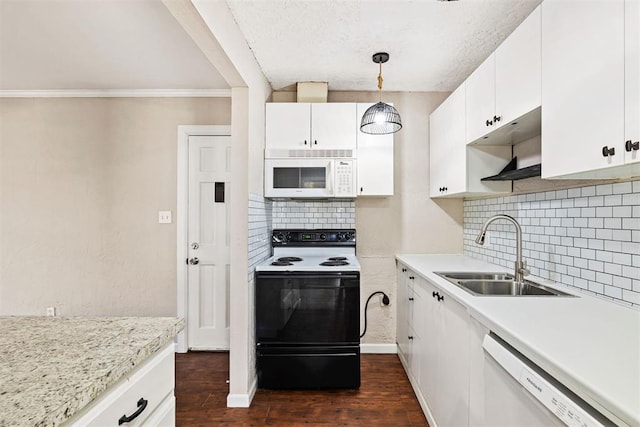 kitchen with dark wood-type flooring, light countertops, white cabinets, white appliances, and a sink