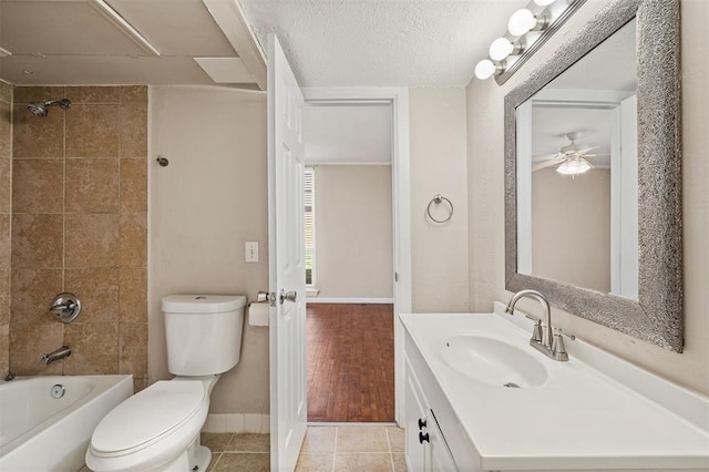 full bathroom featuring toilet, a textured ceiling, tile patterned flooring, bathtub / shower combination, and vanity