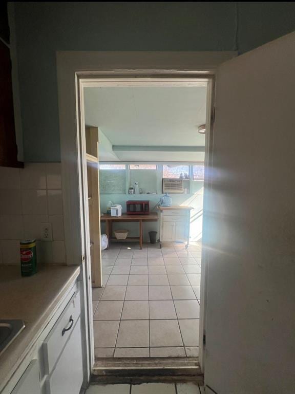 interior space with light tile patterned floors and a sink