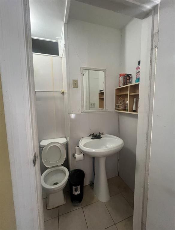 bathroom with tile patterned floors and toilet