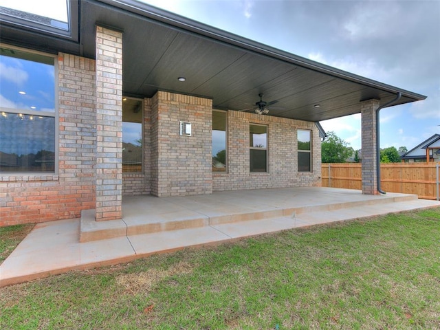 view of patio featuring fence and ceiling fan