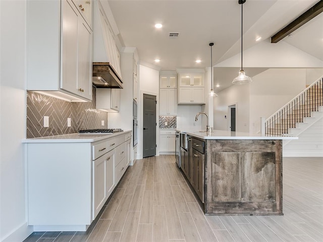 kitchen featuring visible vents, decorative light fixtures, light countertops, appliances with stainless steel finishes, and white cabinets