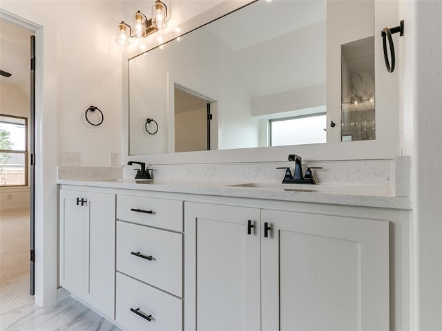 full bathroom featuring a sink, double vanity, and vaulted ceiling