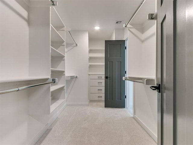 walk in closet with light carpet and visible vents