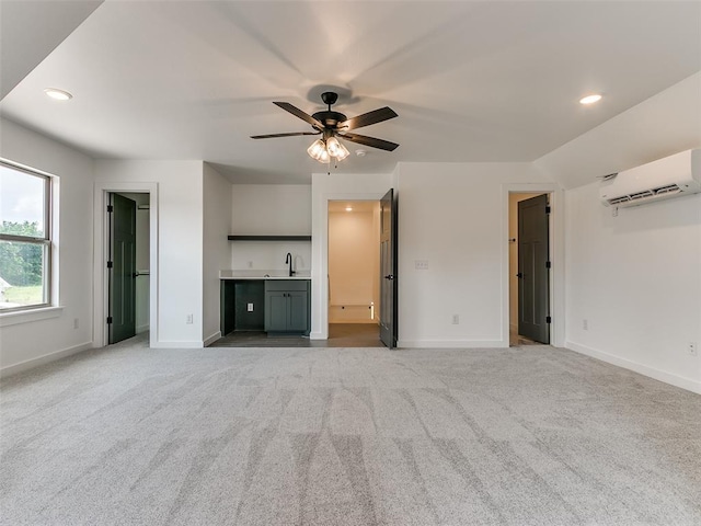 unfurnished living room featuring ceiling fan, baseboards, carpet floors, and a wall mounted AC